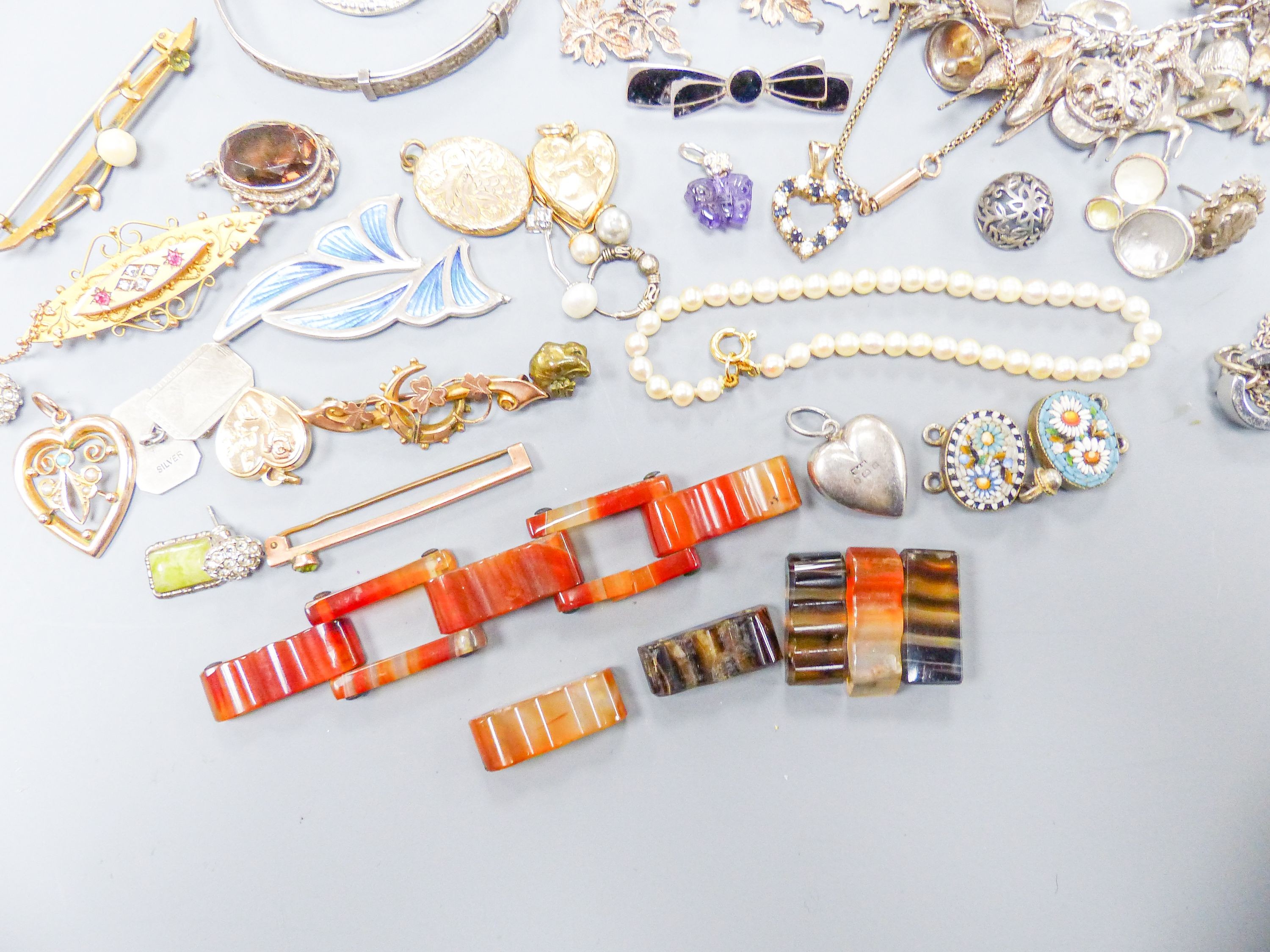 Assorted gold and silver jewellery including bar brooches, charm bracelet etc.